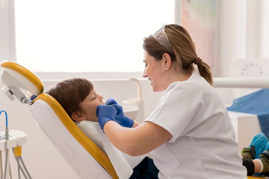 Dentist cleaning a child’s teeth during a routine dental checkup at ZPD: Zionsville Pediatric Dentistry
