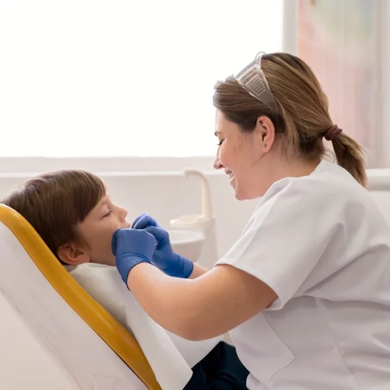 Dentist cleaning a child’s teeth during a routine dental checkup at ZPD: Zionsville Pediatric Dentistry