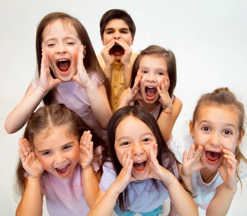 Happy young boys and girls in stylish casual clothes smiling confidently at ZPD: Zionsville Pediatric Dentistry